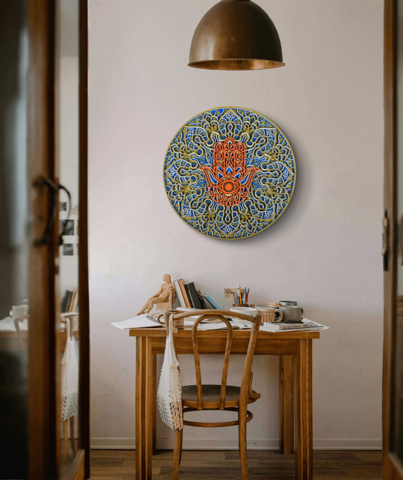 Decorative wall art above a wooden table in a room with a lamp and books.