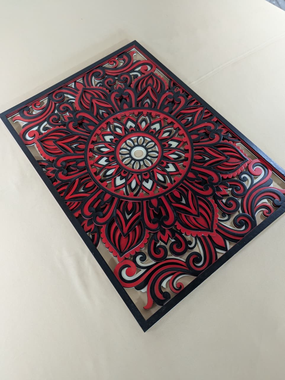 Agnira crimson red mandala wall art displayed on a modern interior wall