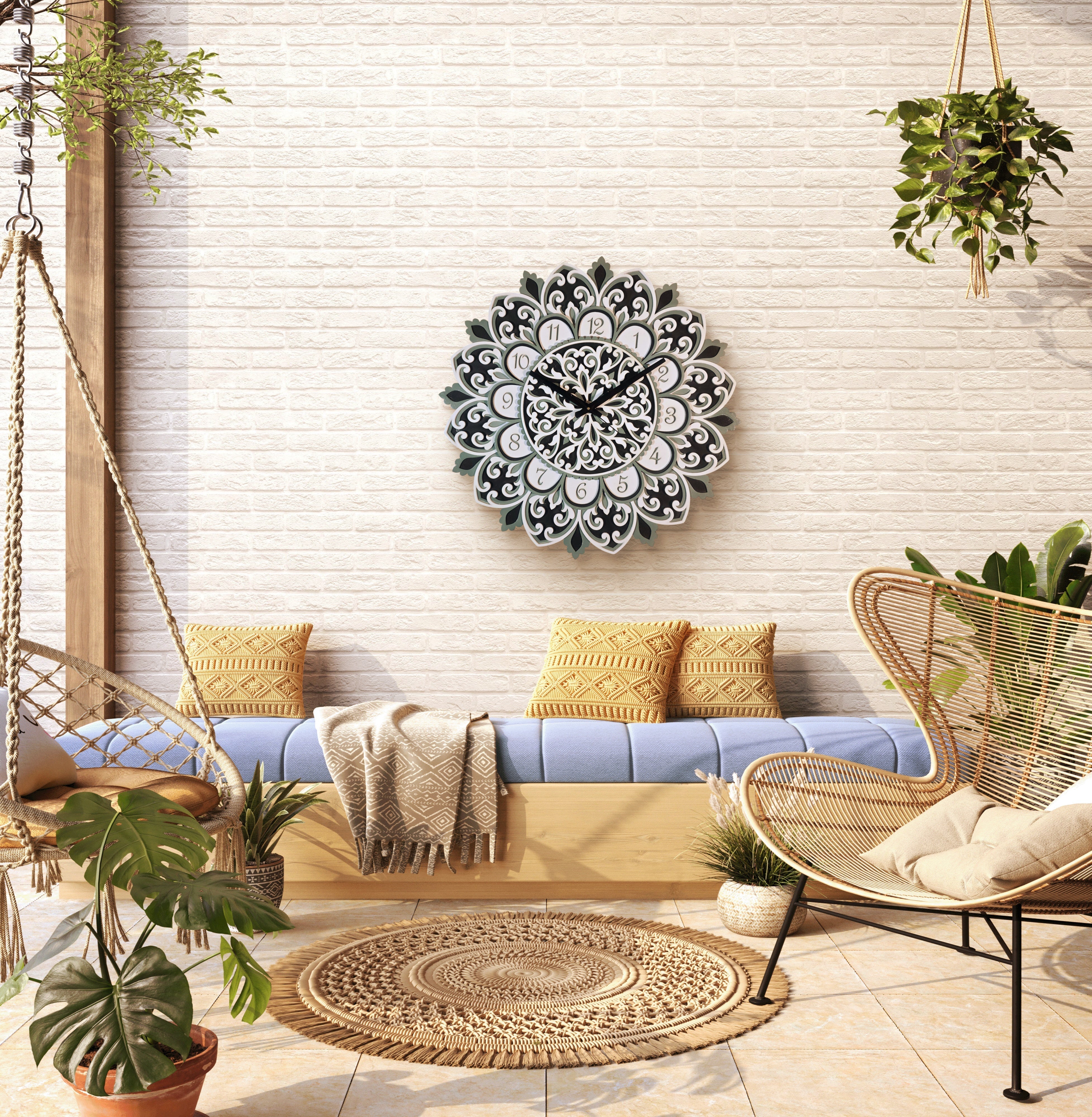 Decorative wall clock on a white brick wall with a couch, chair, and plants in a room.