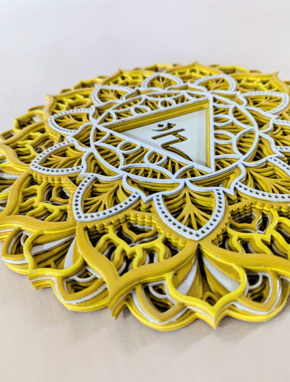 Intricate laser-cut Manipura chakra mandala detailing on wooden wall art