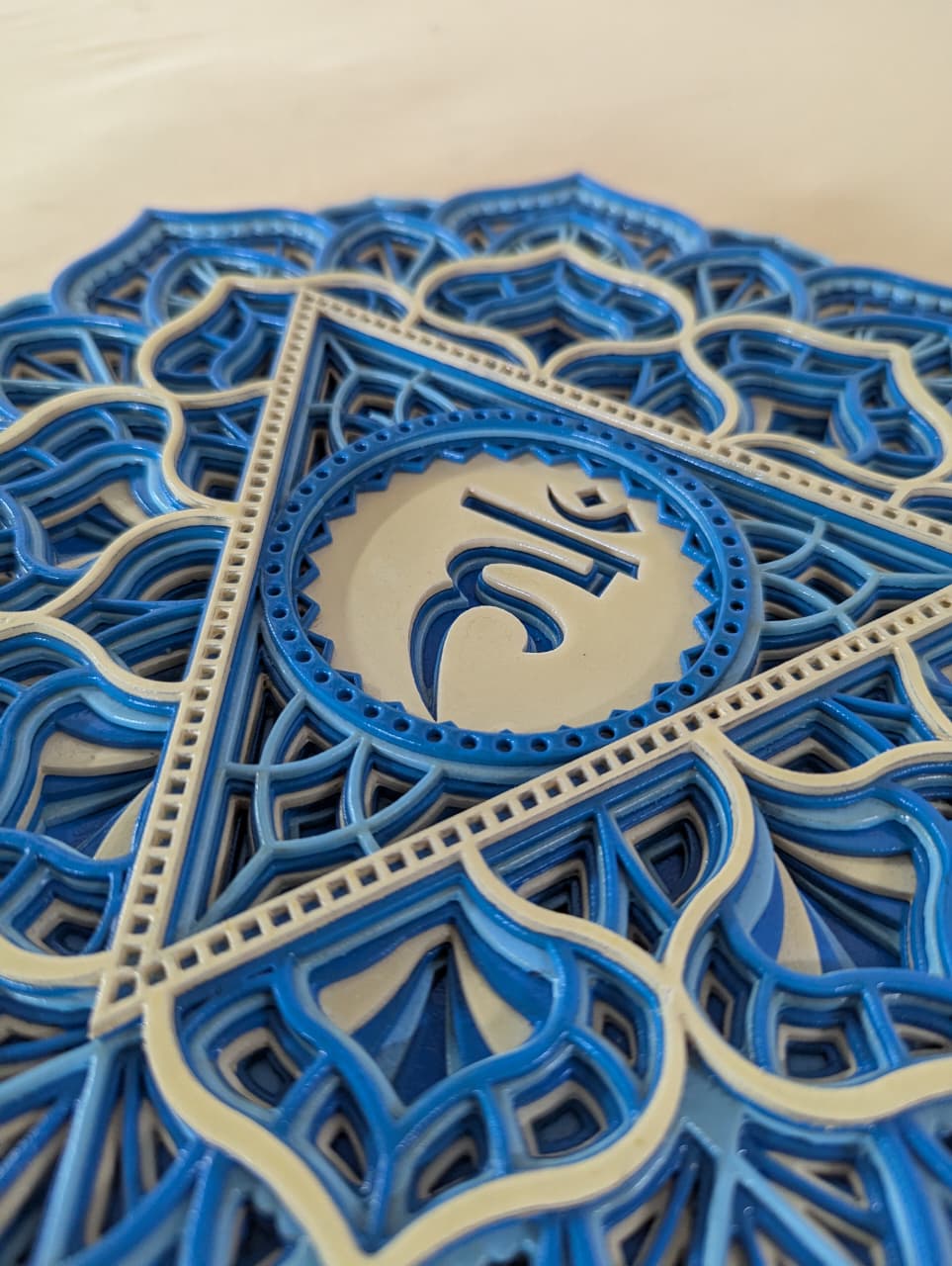 Intricate laser-cut Vishuddha chakra mandala detailing on wooden wall art